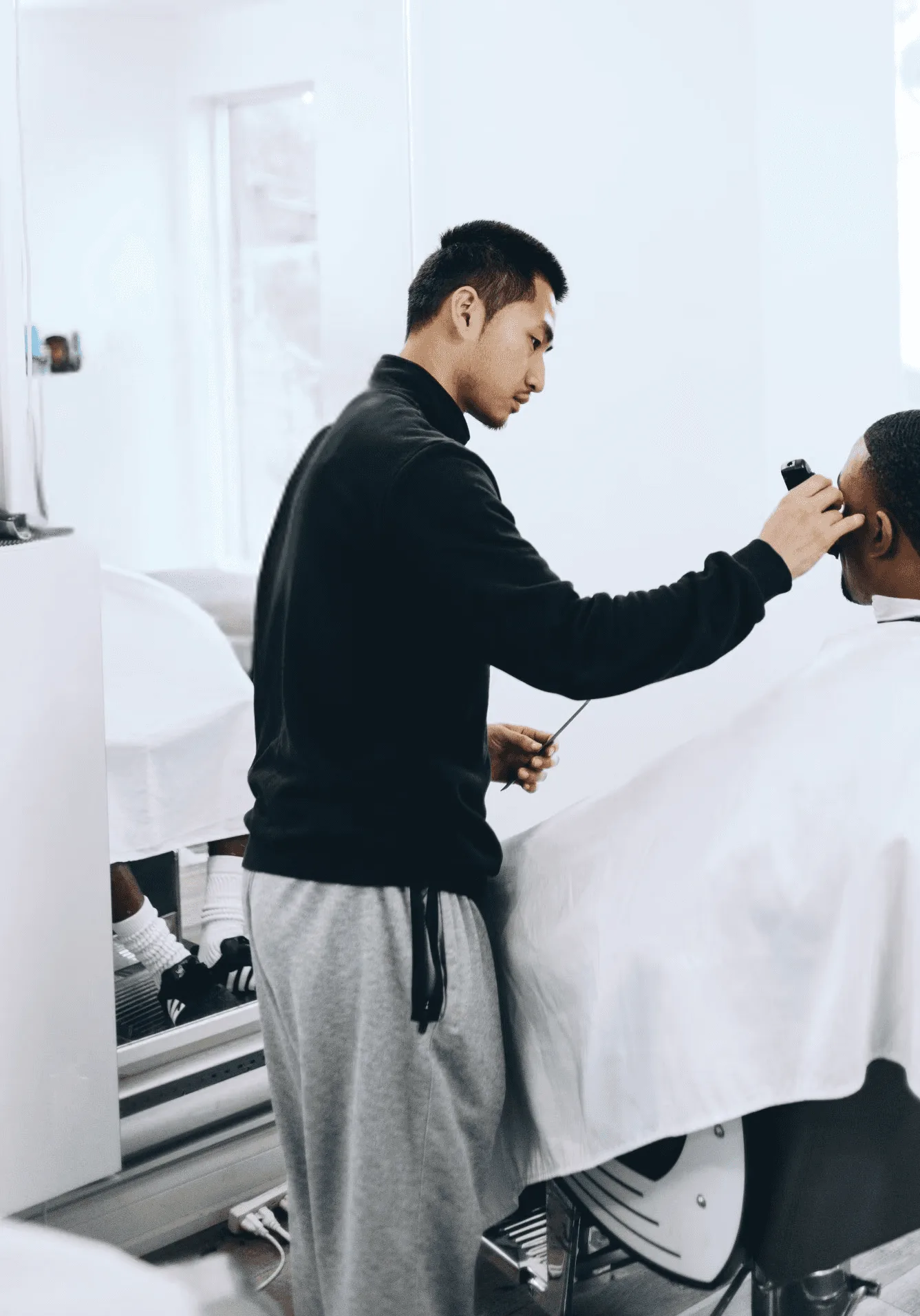 Richard Lam at work in the barbershop